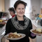 a-woman-serving-food-at-a-kaffemik-in-oqaatsut-in-greenland