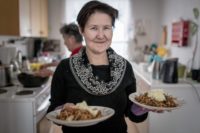 a-woman-serving-food-at-a-kaffemik-in-oqaatsut-in-greenland